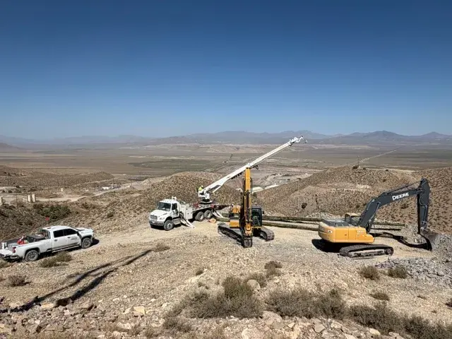 Construction equipment along a hillside work area