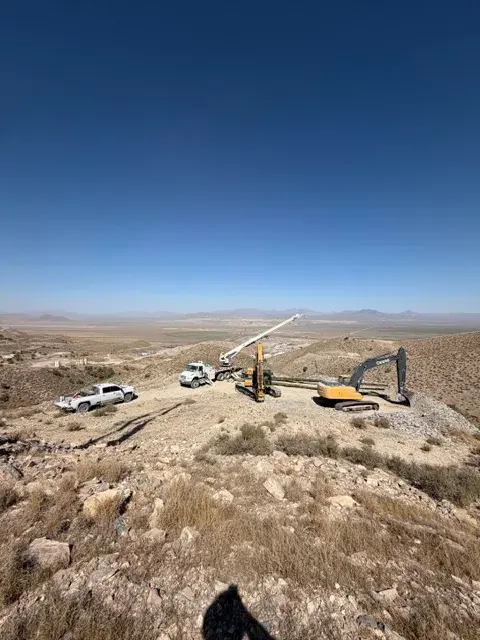 Equipment and poles across an open field work area