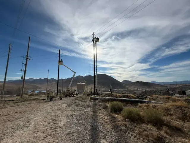 Utility poles beneath a clouded sky