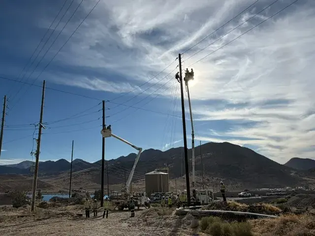 Overhead utility lines along a mountain slope