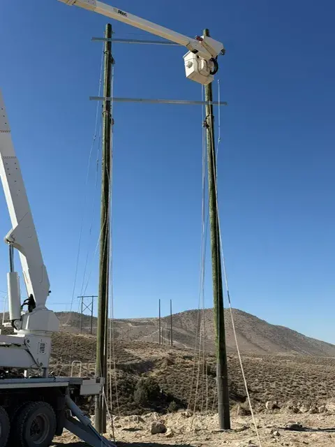 Bucket truck working beside a utility pole