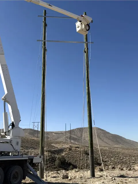 Bucket truck raised beside an overhead pole
