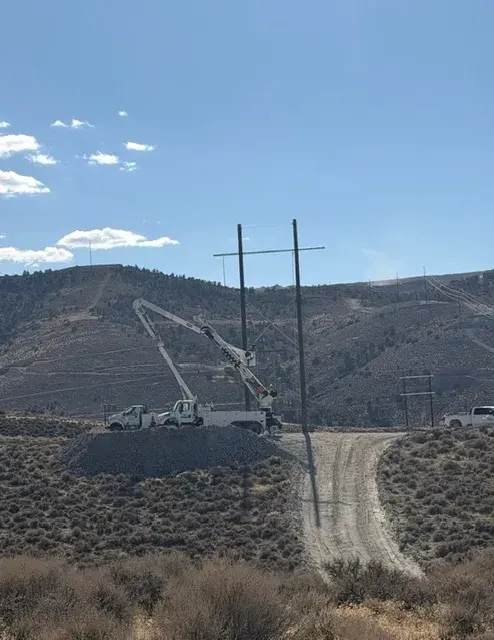Utility poles crossing a mountain landscape