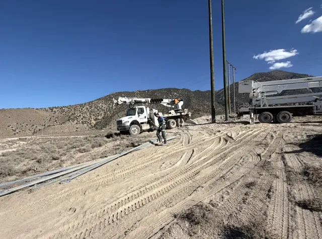 Field trucks along an unpaved access road