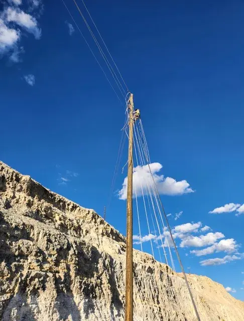 Utility pole beside a rocky slope