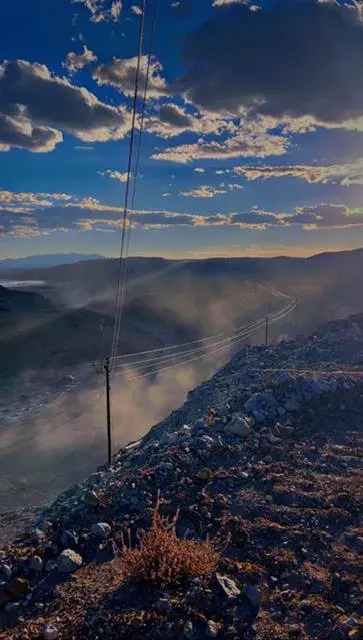 Mountain landscape beneath a clouded evening sky
